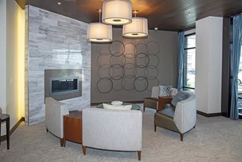 Second community room with a fireplace lounge and comfortable seating.